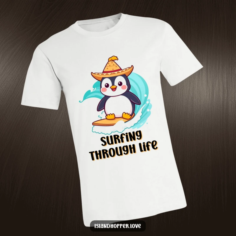 Funny T-Shirt: A happy penguin wearing a small sombrero surfs a vibrant turquoise wave, showcasing ocean adventure and fun.